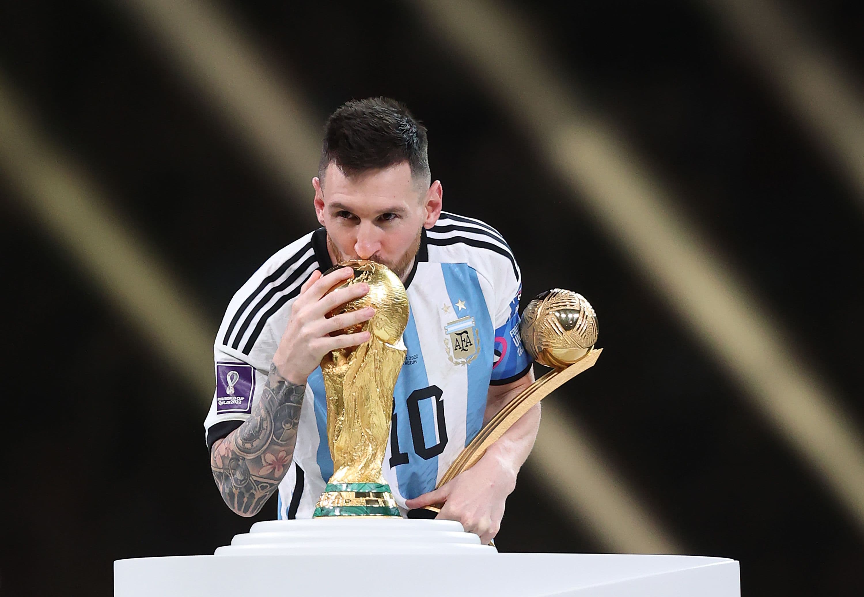Lionel Messi holding the World Cup trophy