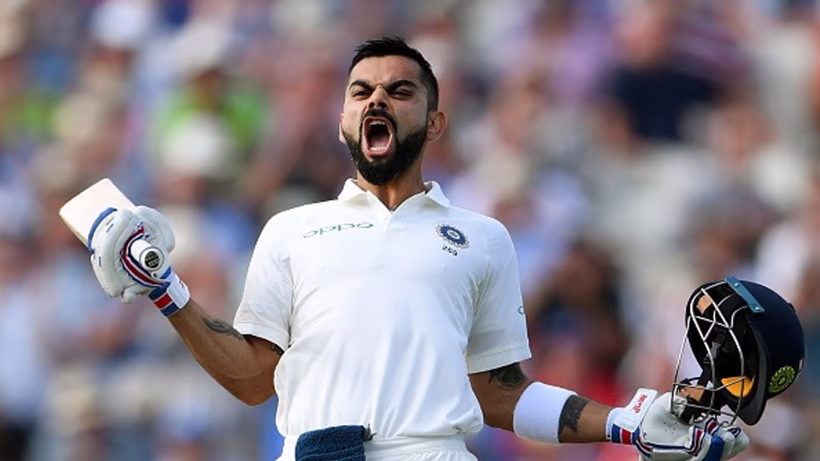 Virat Kohli celebrating with his cricket bat and helmet